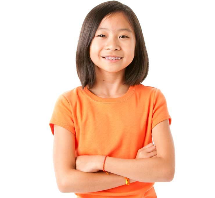 Girl with arms folding in orange shirt